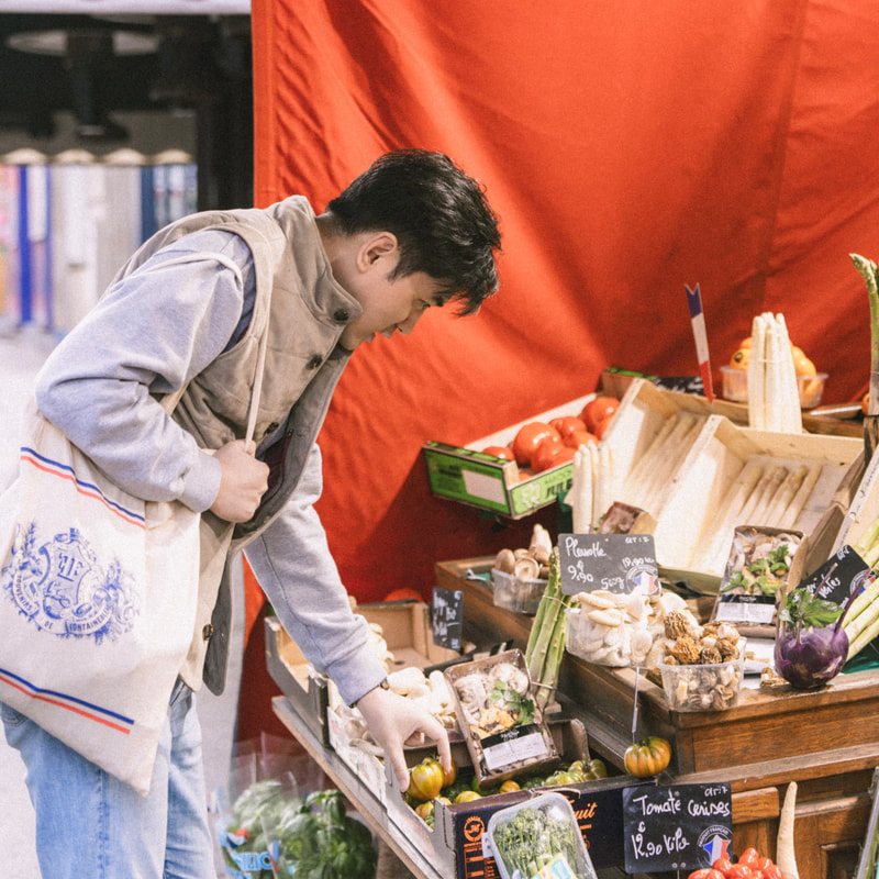 Chef Zhou J., Yan-Yeu selecting fresh ingredients at the market